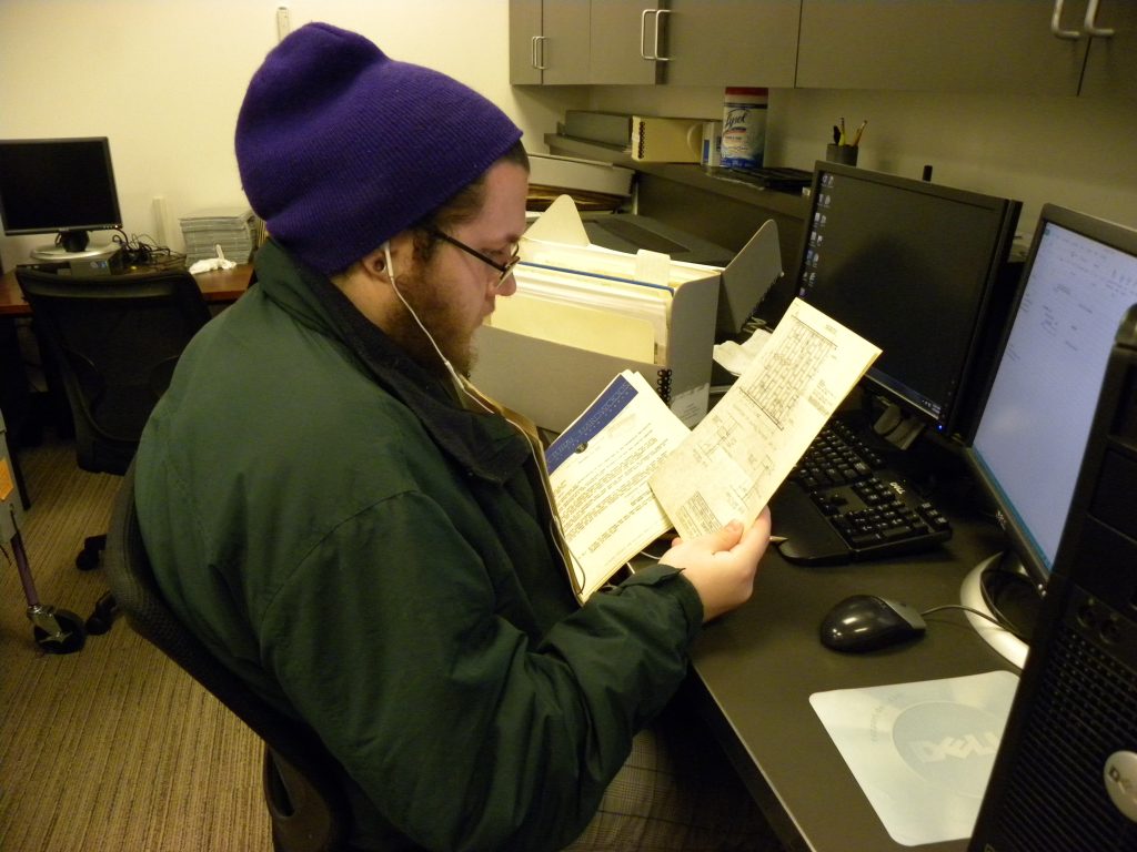 Internship student Zach Britton with documents