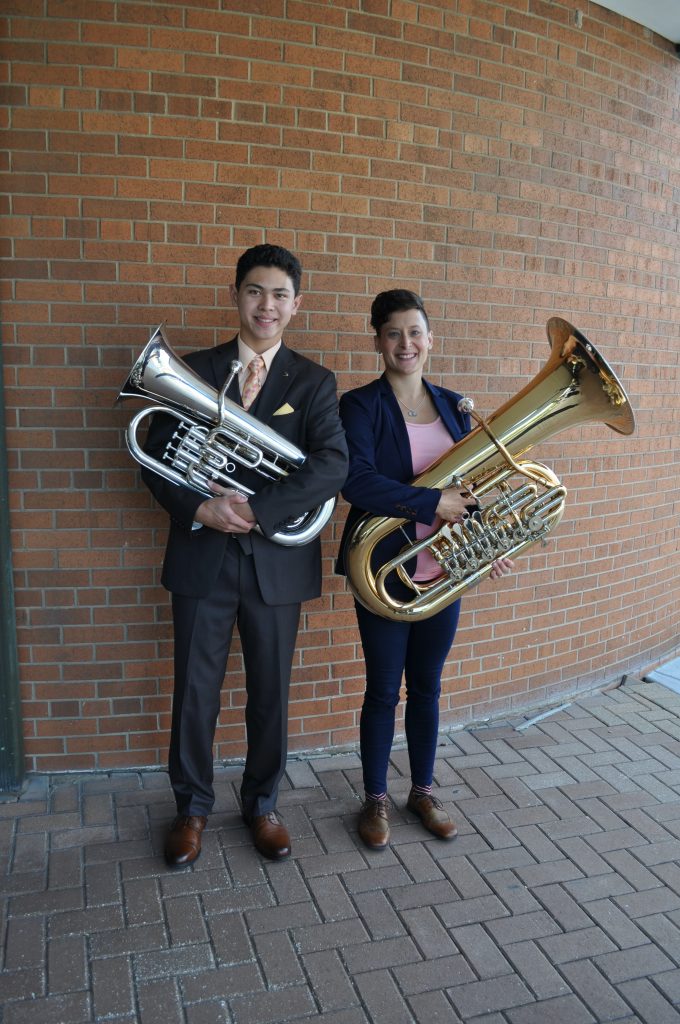 Matthew Yee and a colleague posing with their musical intruments