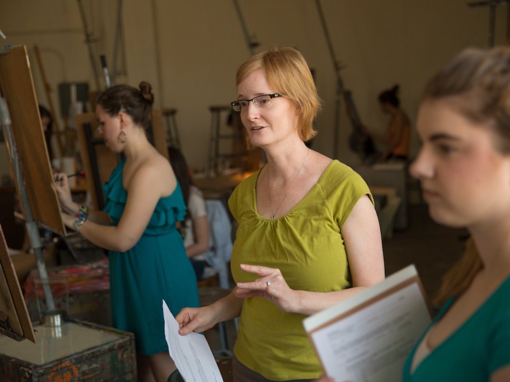 Instructor with the students in a painting class