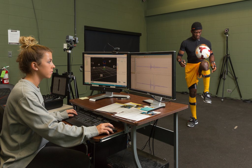 A bioengineering student collects data to study the movements of an athlete.