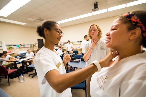 Students practice physical exams in the College of Nursing