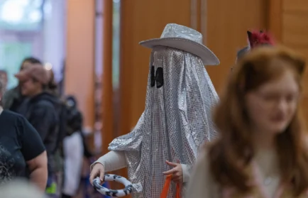 A person in a silver holographic ghost costume and cowboy hat at a Valparaiso University Halloween event.