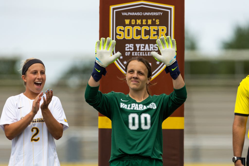 Nikki Coryell '24 smiles and waves at fans.