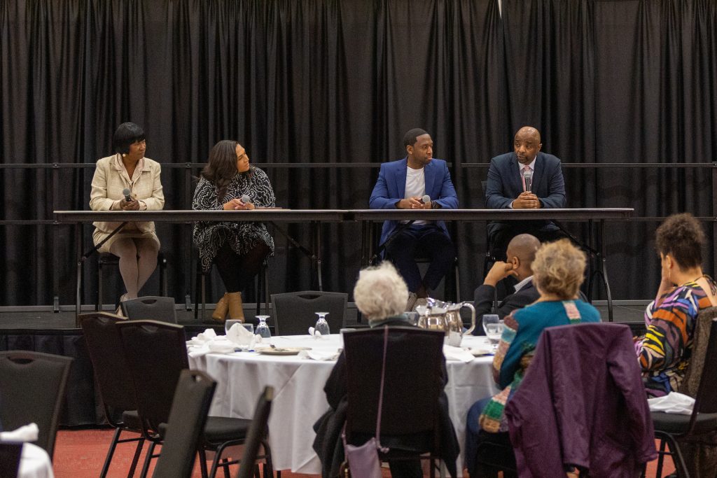 Panelists sitting on stage for BHM dinner.