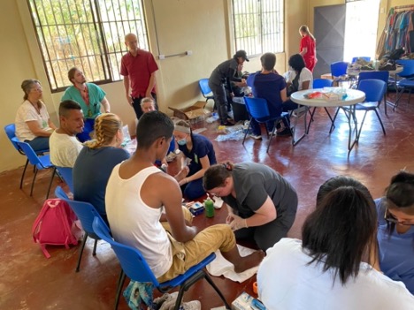 Valpo CONHP students performing foot washing ceremony for patients in Costa Rica. 