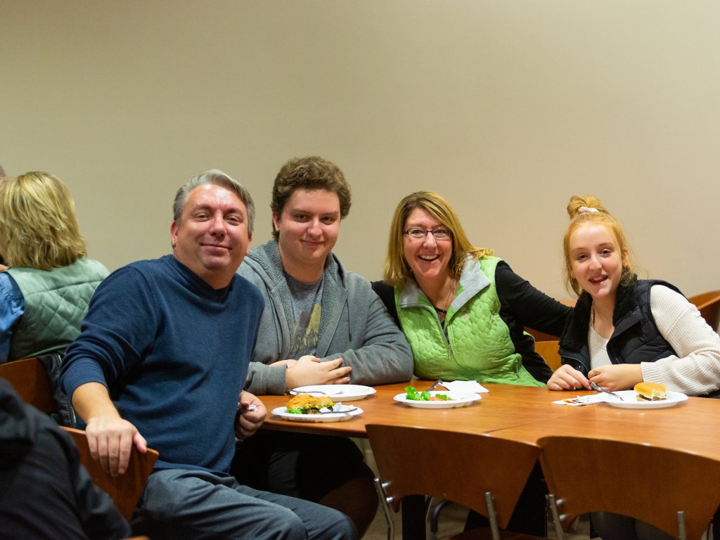Students & parents smile while attending the Valpo family weekend welcome dinner.