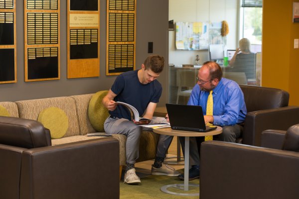 A student and academic counselor sit and discuss college admissions and Valparaiso University tuition.