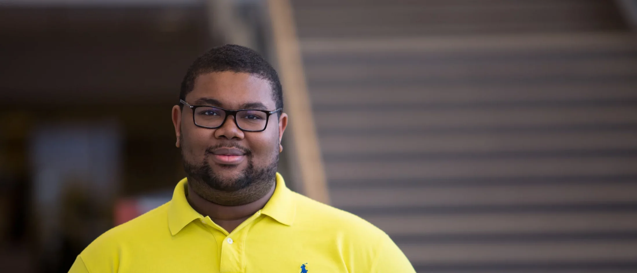 A Valpo student wearing a yellow polo shirt.