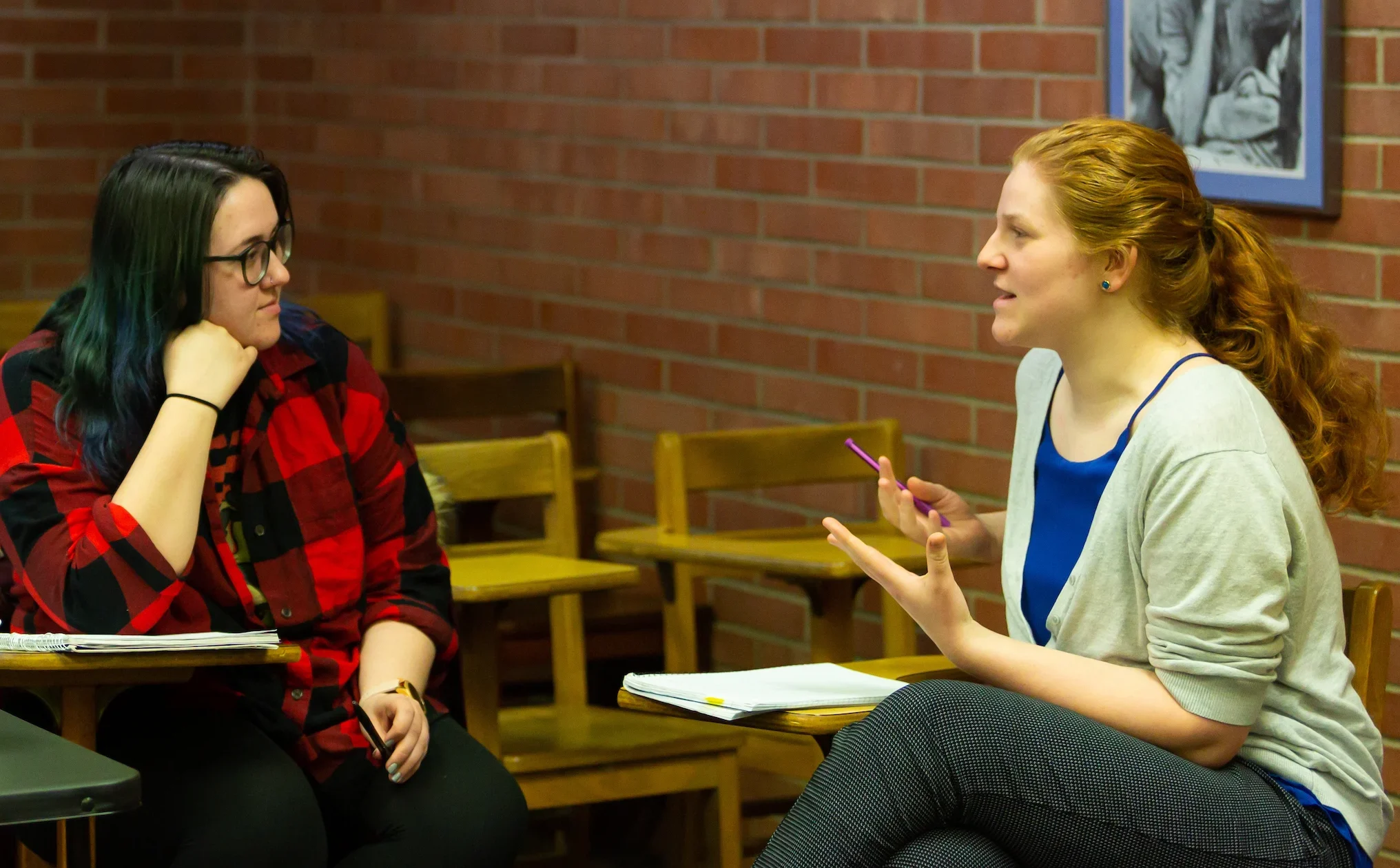 Two Valparaiso University social work students engage in one-on-one conversation in a classroom.