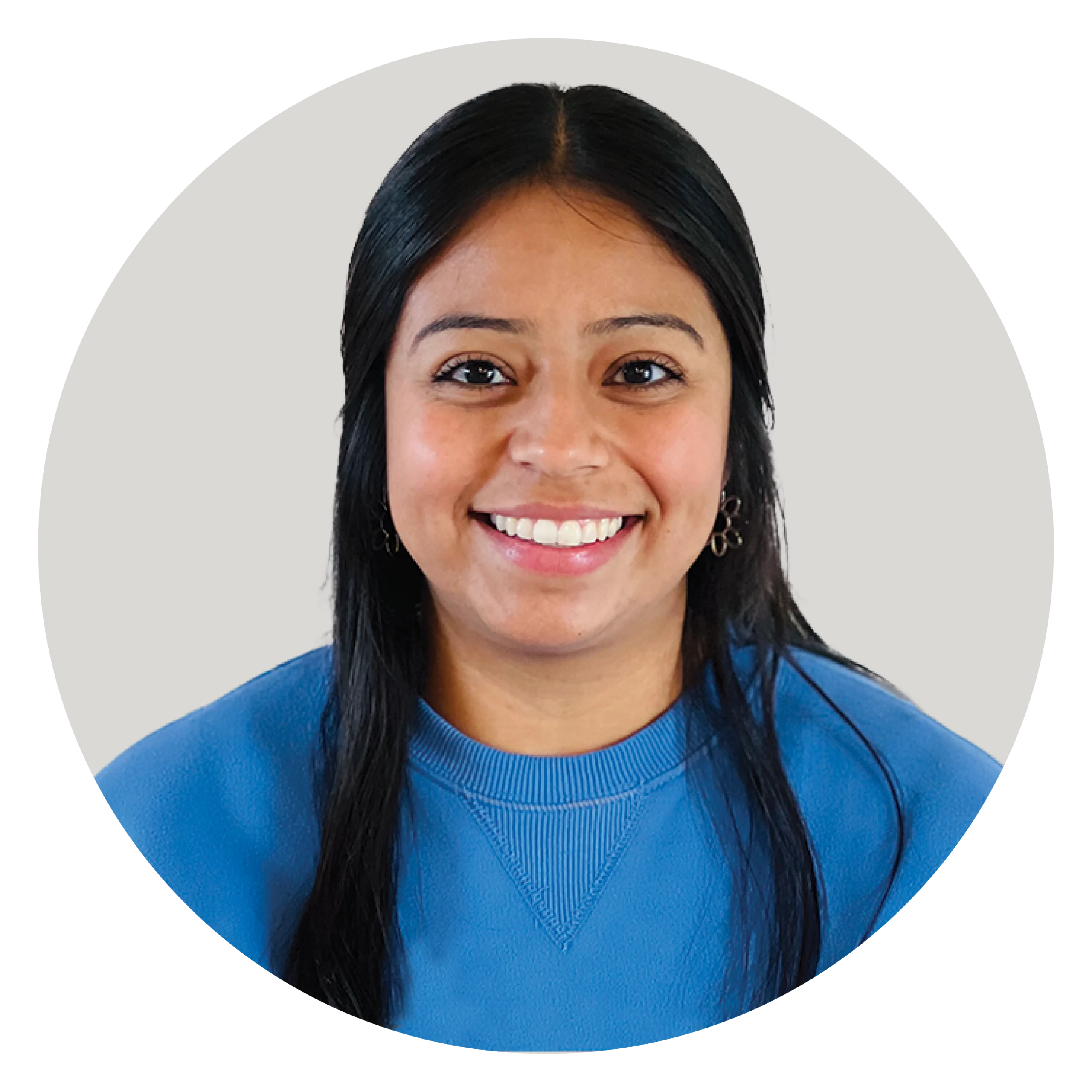 Maria Camacho, a smiling woman with long dark hair in a blue sweater, faces forward against a light gray background, representing the Health Science Program.