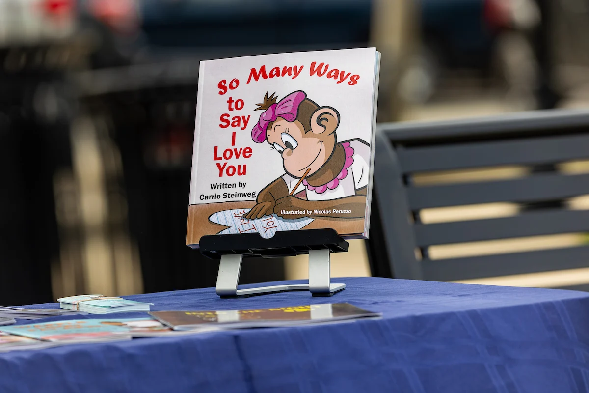Children’s book titled "So Many Ways to Say I Love You" with a cartoon bear on a table display.