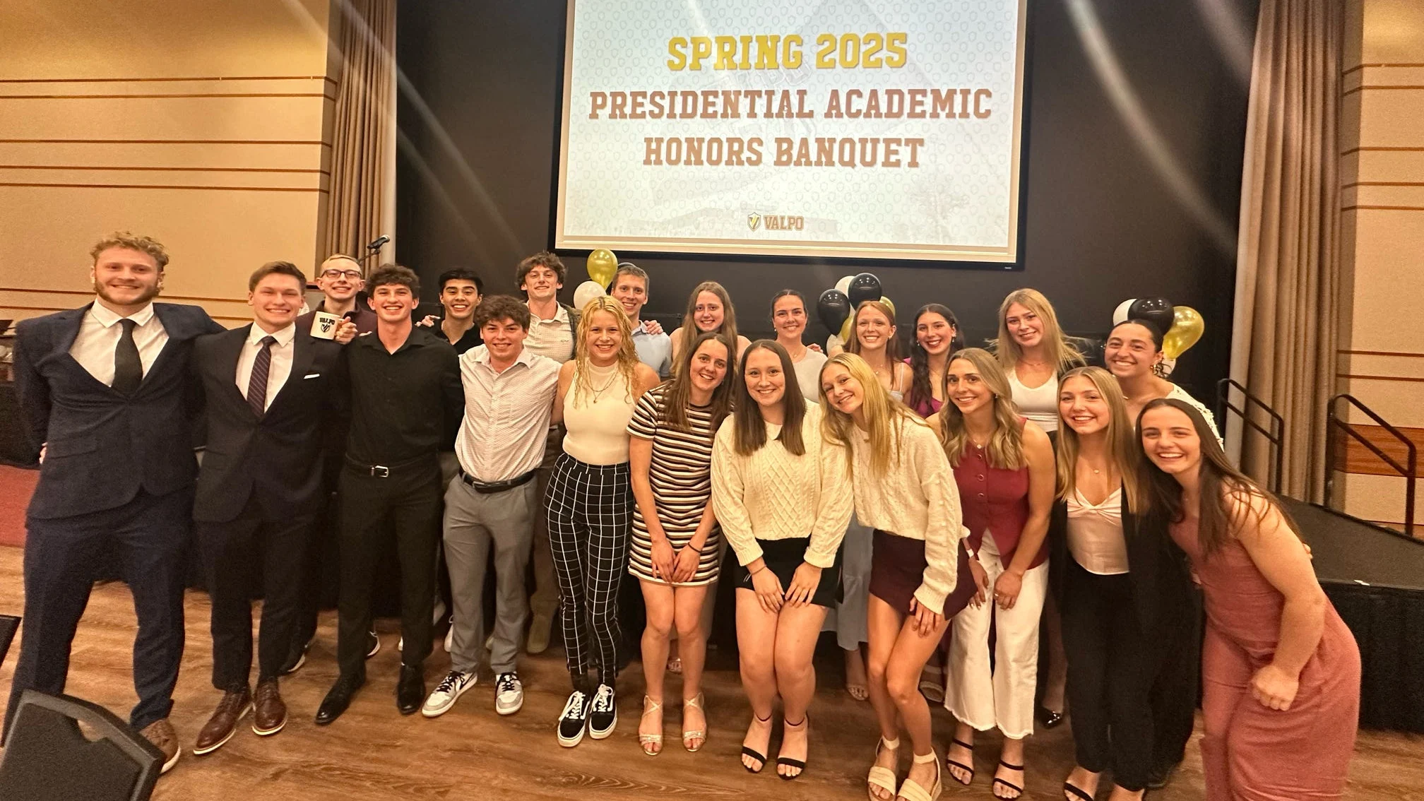 A group of students, including up-and-coming career achiever Ricky Helmboldt, posing together at the Spring 2023 Presidential Academic Honors Banquet.