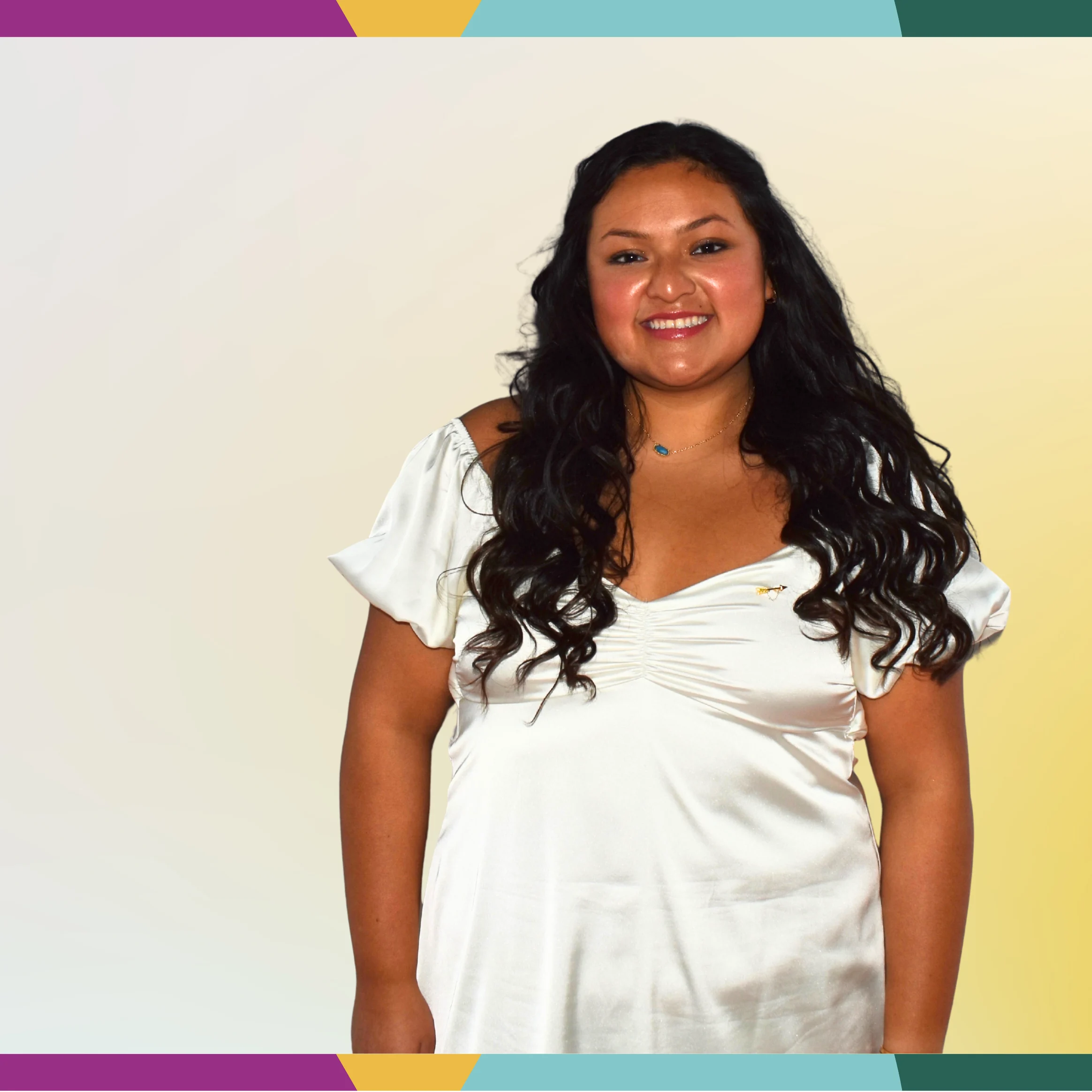 Smiling woman with long dark hair wearing a white dress, standing against a colorful geometric border background, celebrates multicultural diversity.