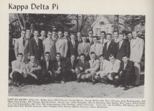 A group of young men in suits poses outdoors for a Kappa Delta Pi fraternity photo, 1950s era.