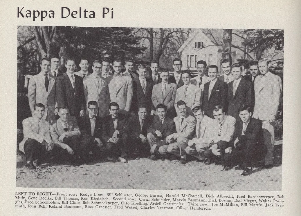 A group of young men in suits poses outdoors for a Kappa Delta Pi fraternity photo, 1950s era.