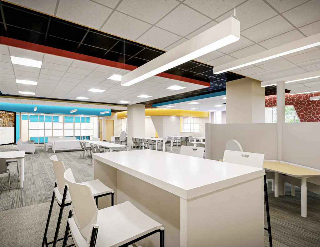 Modern, open office space in Loke Hall with white desks, chairs, and colorful accent walls in blue, red, and yellow.