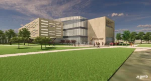 A modern university building, the CONHP Building at Valpo, features glass and beige panels, surrounded by lawns, trees, and people walking—a testament to a transformative gift.