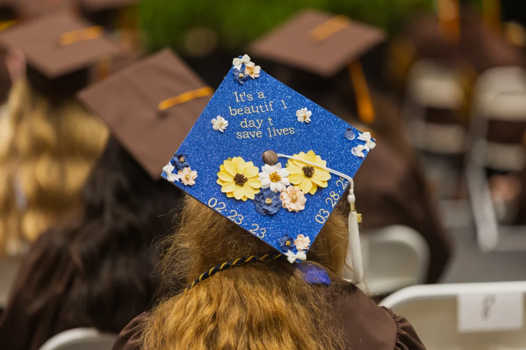 A blue graduation cap decorated with flowers and the words, “It’s a beautiful day to save lives,” celebrates the accomplishments of health professions students in our community at CASS.