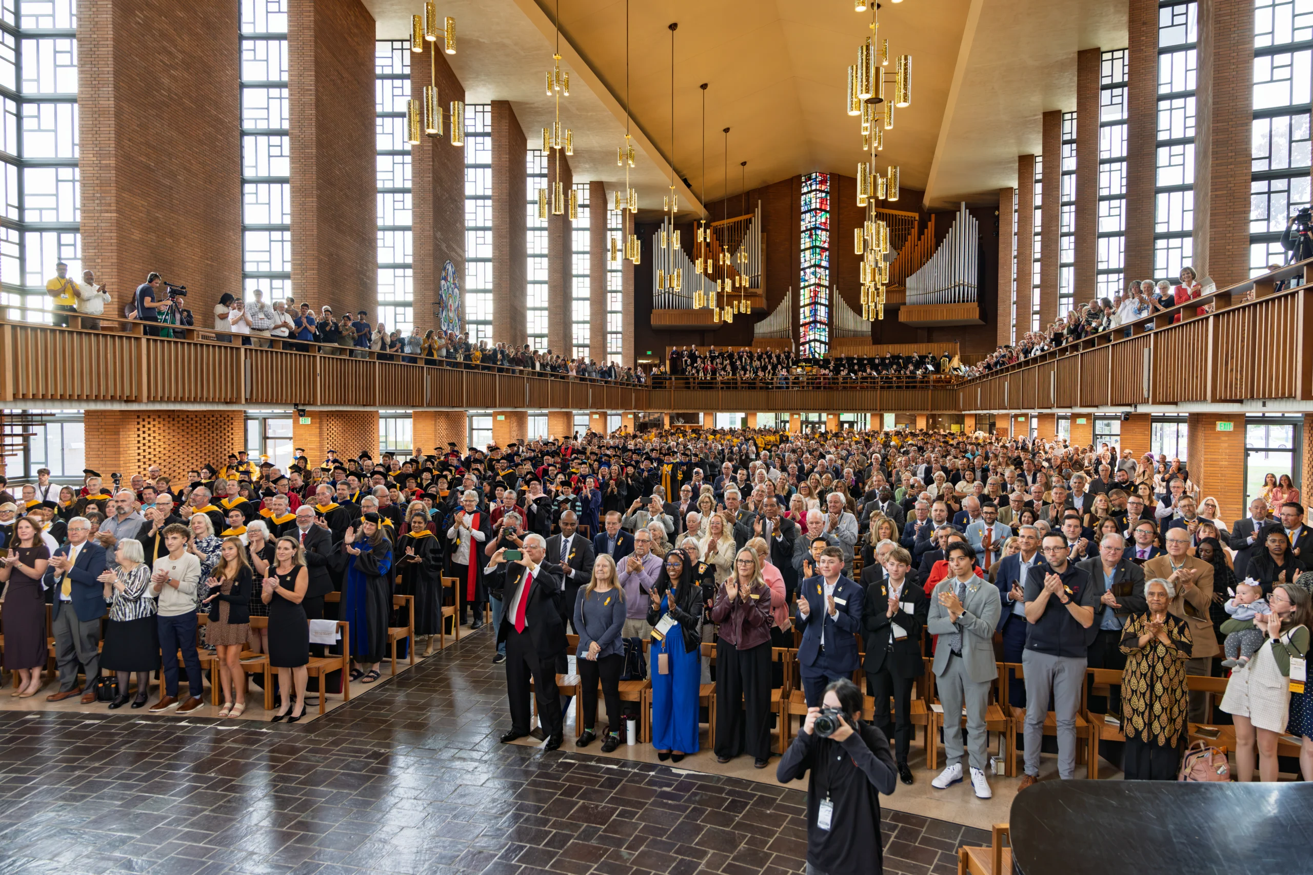 A standing crowd applauds the inauguration of Rev. Brian Konkol, 20th president of Valparaiso University