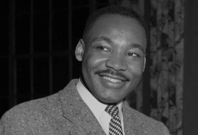 Black and white portrait of Martin Luther King Jr. smiling for the MLK Awards.